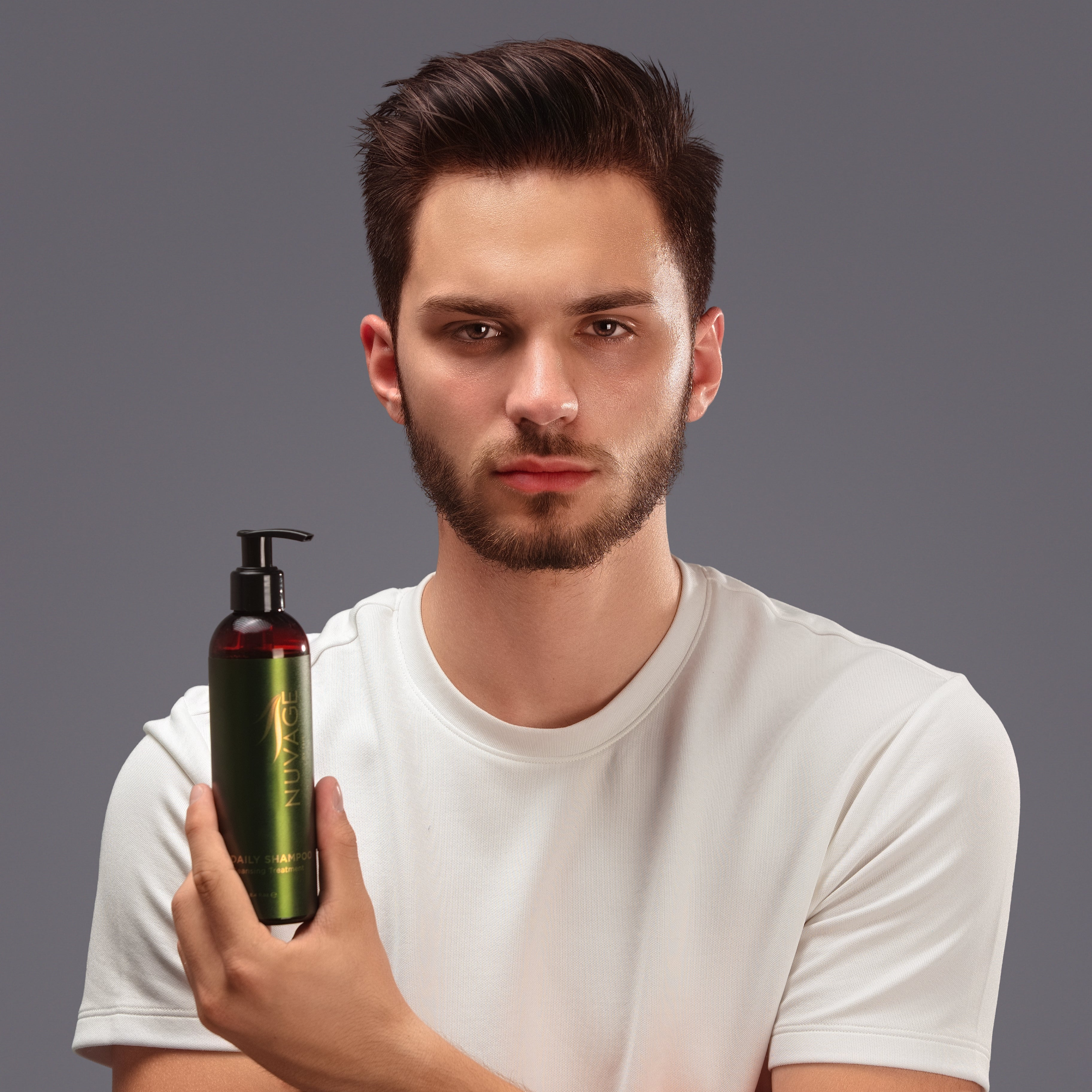 Daily Shampoo - Body&Hair held by a model showcasing its versatile use for hair and skin.