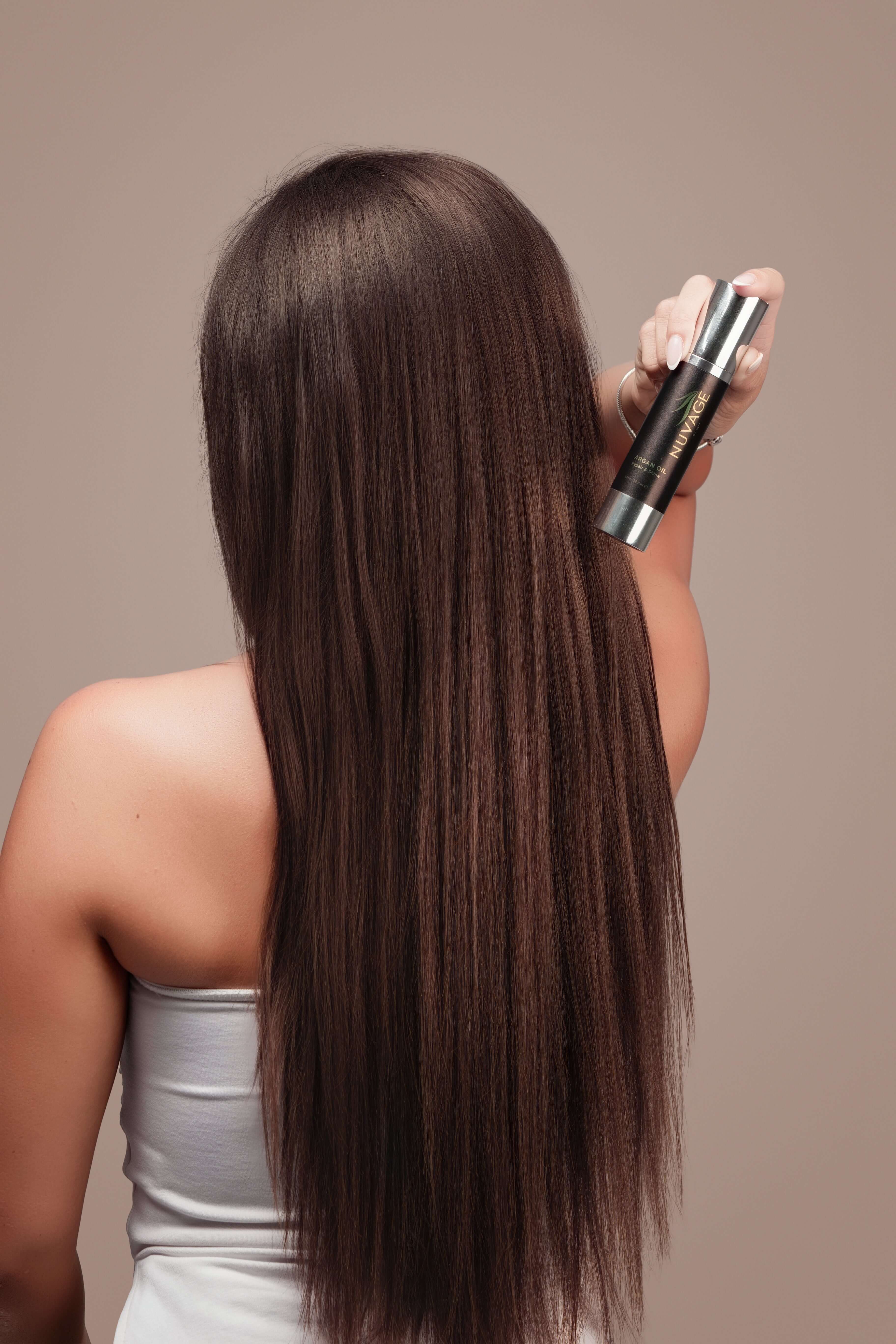 Argan Oil Hair & Beard Treatment Pure Moroccan showcased by a model with sleek, shiny hair.