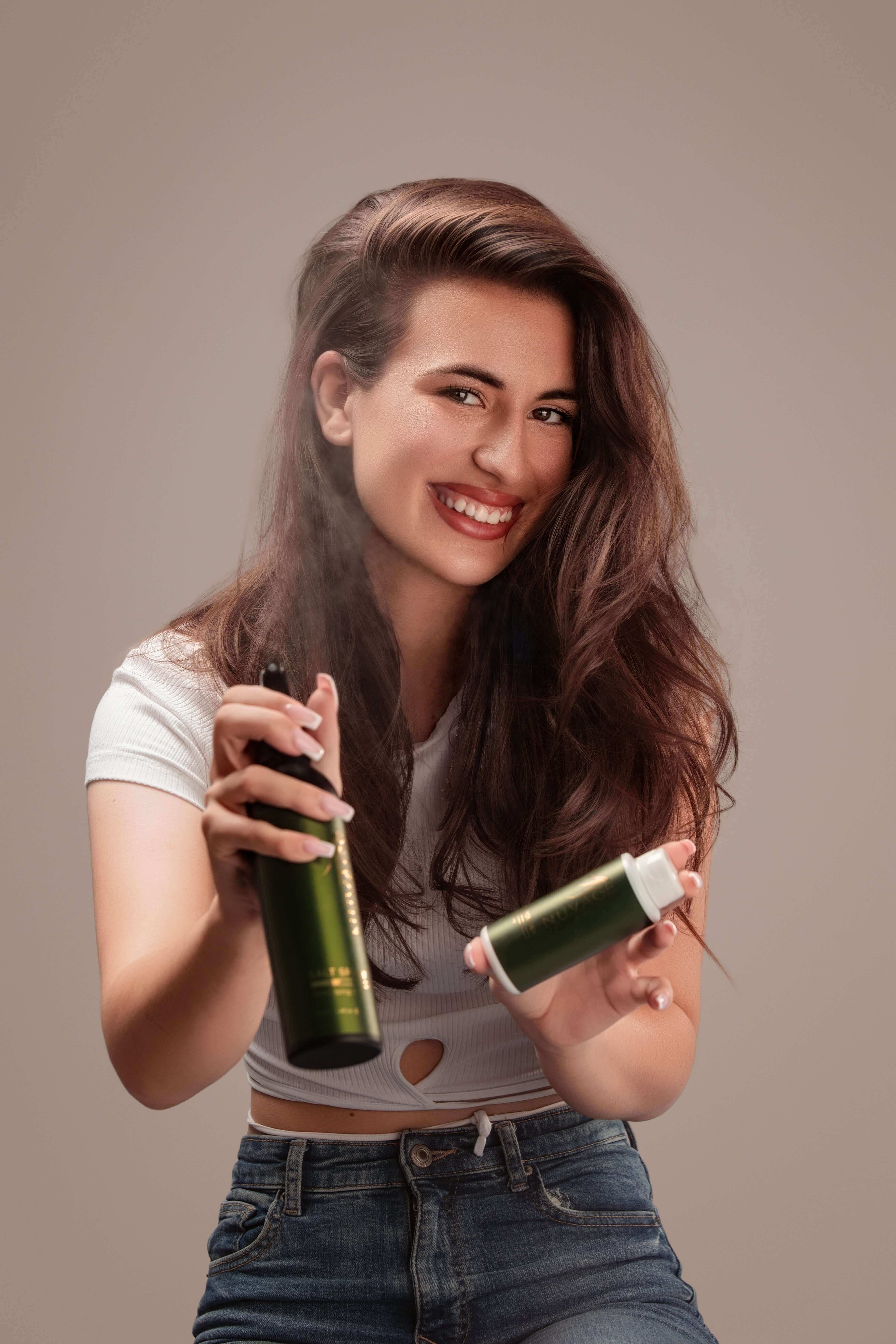 Smiling woman holding Volume Powder 20g Professional Hair Texture and hair spray for weightless volume.